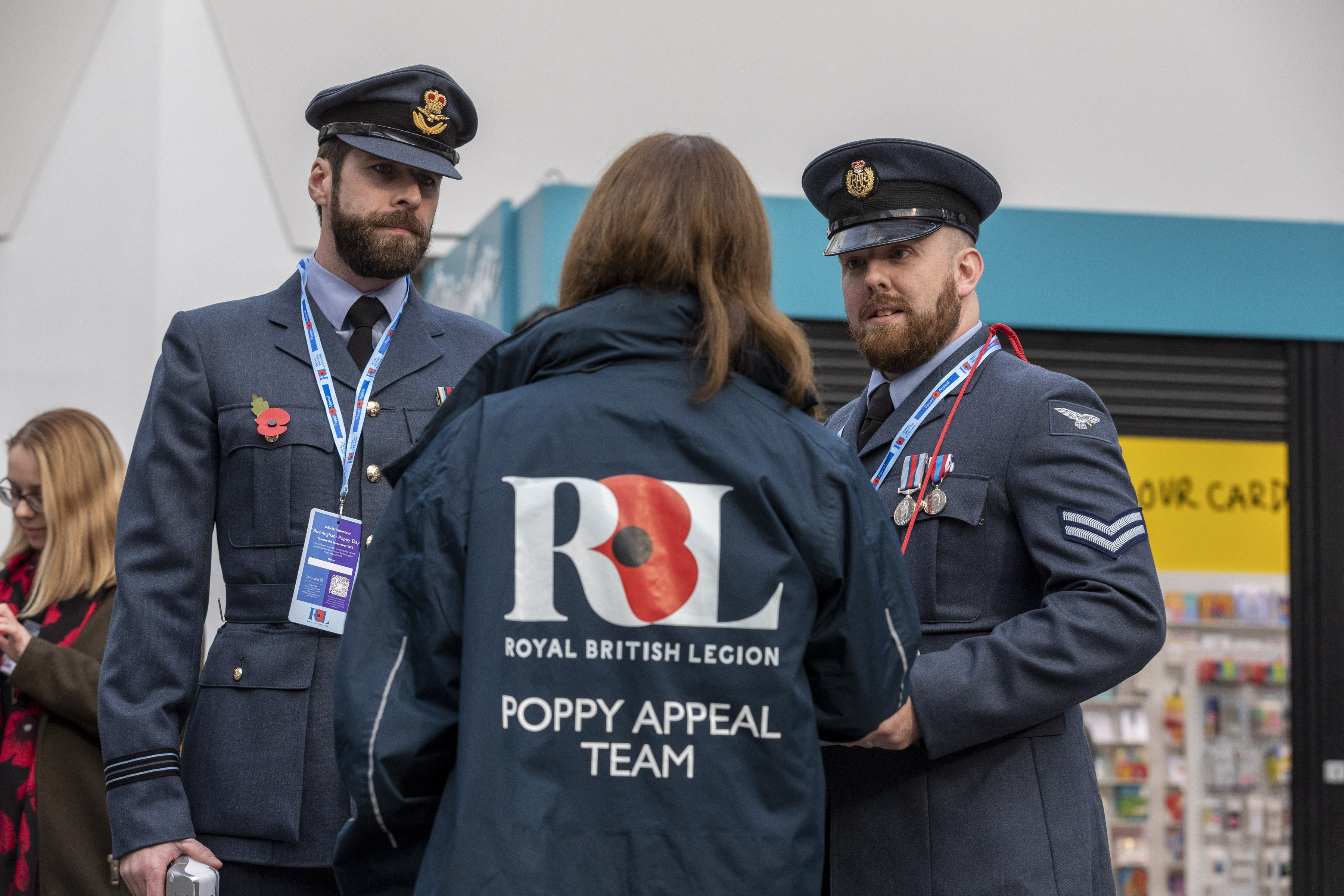 Image shows RAF aviators and Royal British Legion worker in shopping centre.